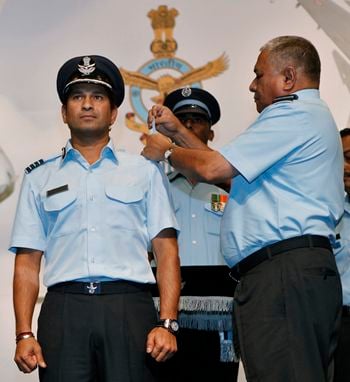 P V Naik, chief of the Indian Air Force, presents the honorary rank of Group Captain to cricketer Sachin Tendulkar during a ceremony in New Delhi