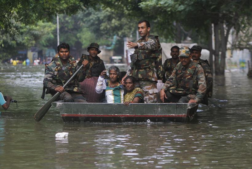 Indian army soldiers rescue flood affected people in Chennai, India, Thursday, Dec. 3, 2015. The heaviest rainfall in more than 100 years has devastated swathes of the southern Indian state of Tamil Nadu, with thousands forced to leave their submerged homes and schools, offices and a regional airport shut for a second day Thursday.( AP Photo)