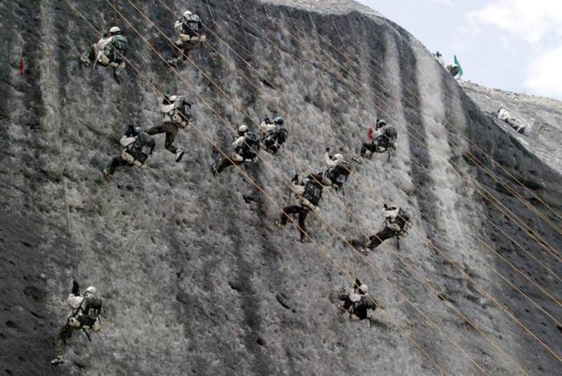 Indian army soldiers climb an ice wall