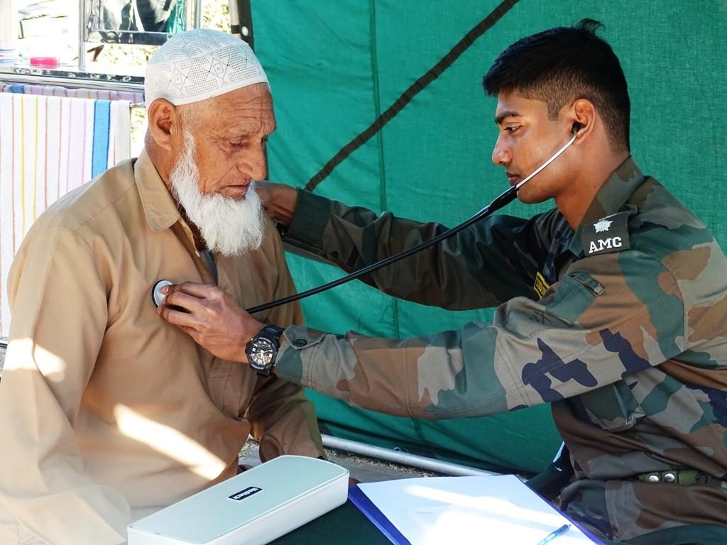 Army Medical Corps Officer Providing Aid To An Elderly Kashmiri Resident