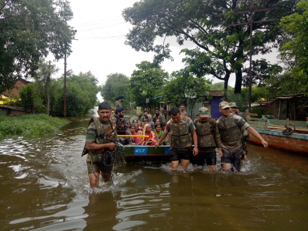 Women being evacuated by Indian army personnel