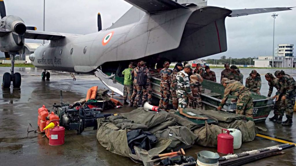 Indian army personnel receiving rescue boats from an IAF aircraft 