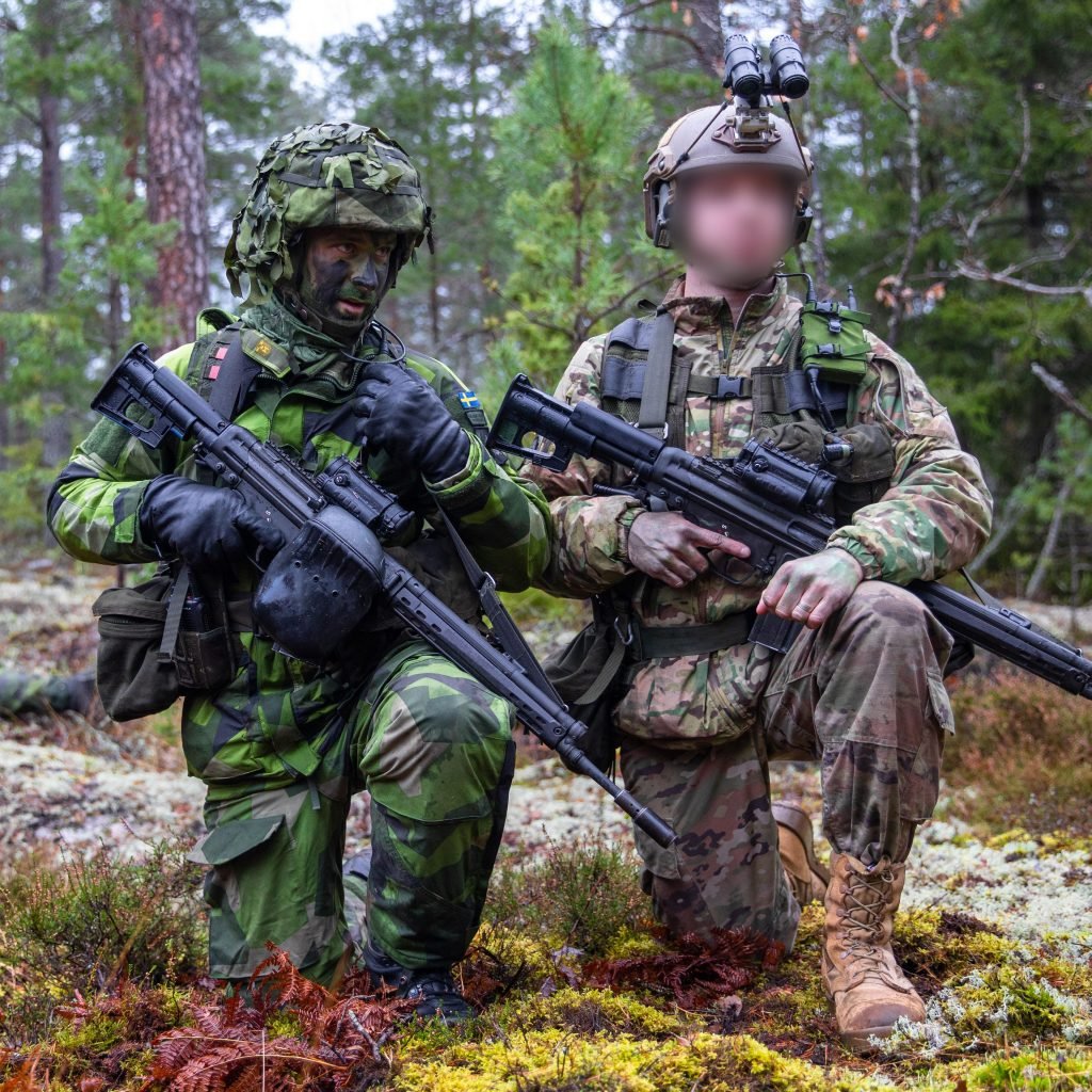 Soldiers from the Swedish Home Guard and a U.S. Army Green Beret assigned to 10th Special Forces Group (Airborne) patrol an area during a bilateral exercise in Sweden, November 26, 2020.