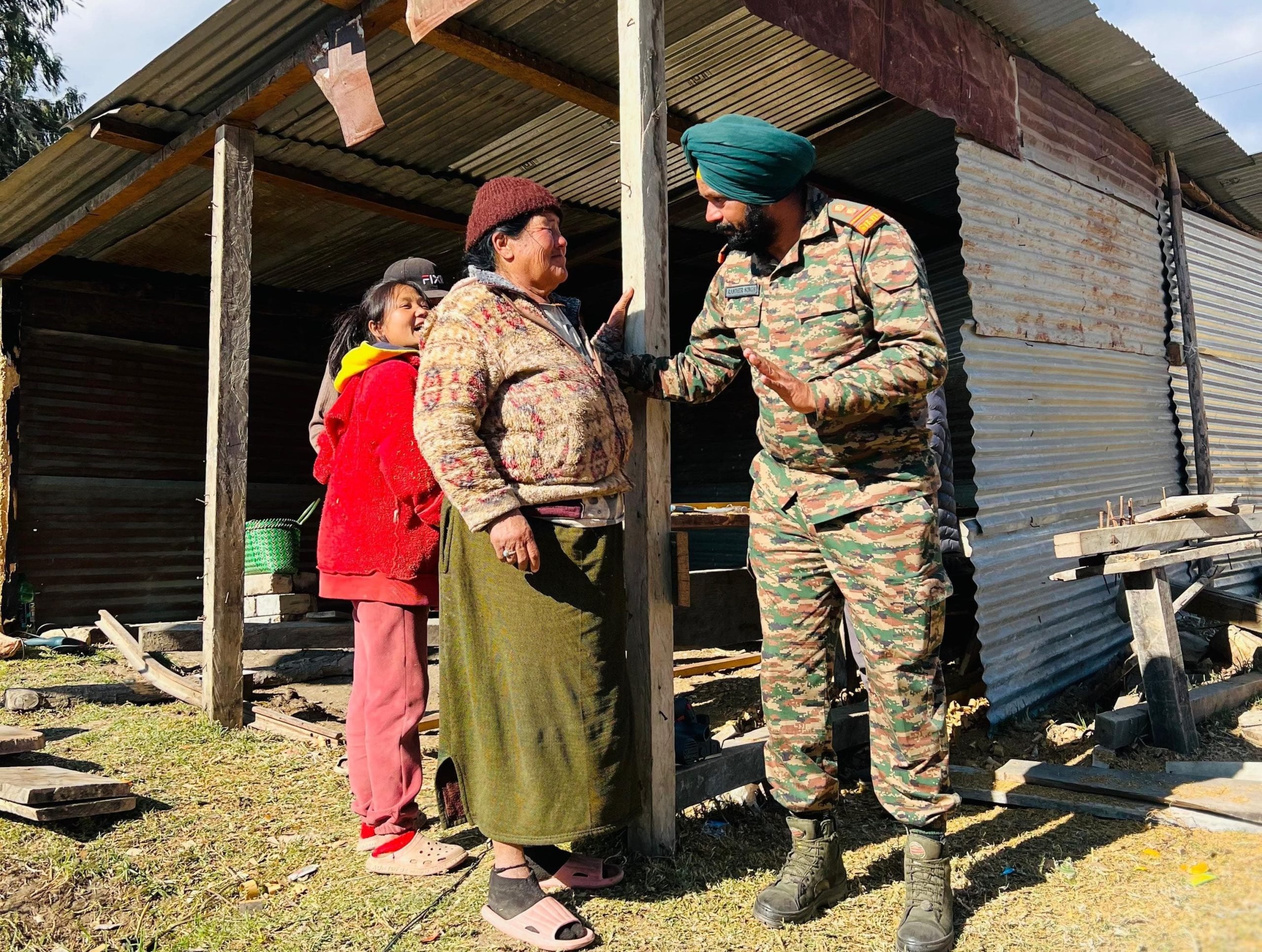 indian army helping a lady scaled